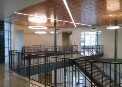 A spiral staircase in a building with metal railings.