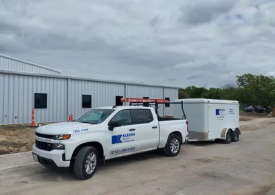 A white truck parked in front of a building.