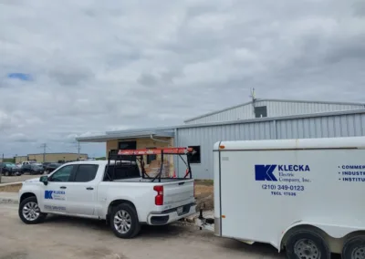 A white truck is parked in front of a building.
