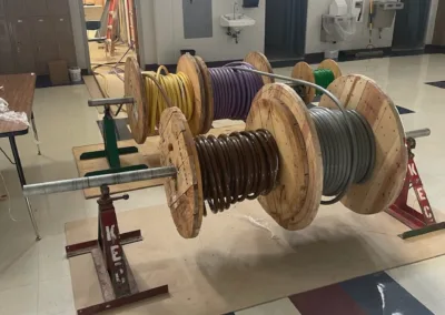 A group of wooden spools on a table in a room.